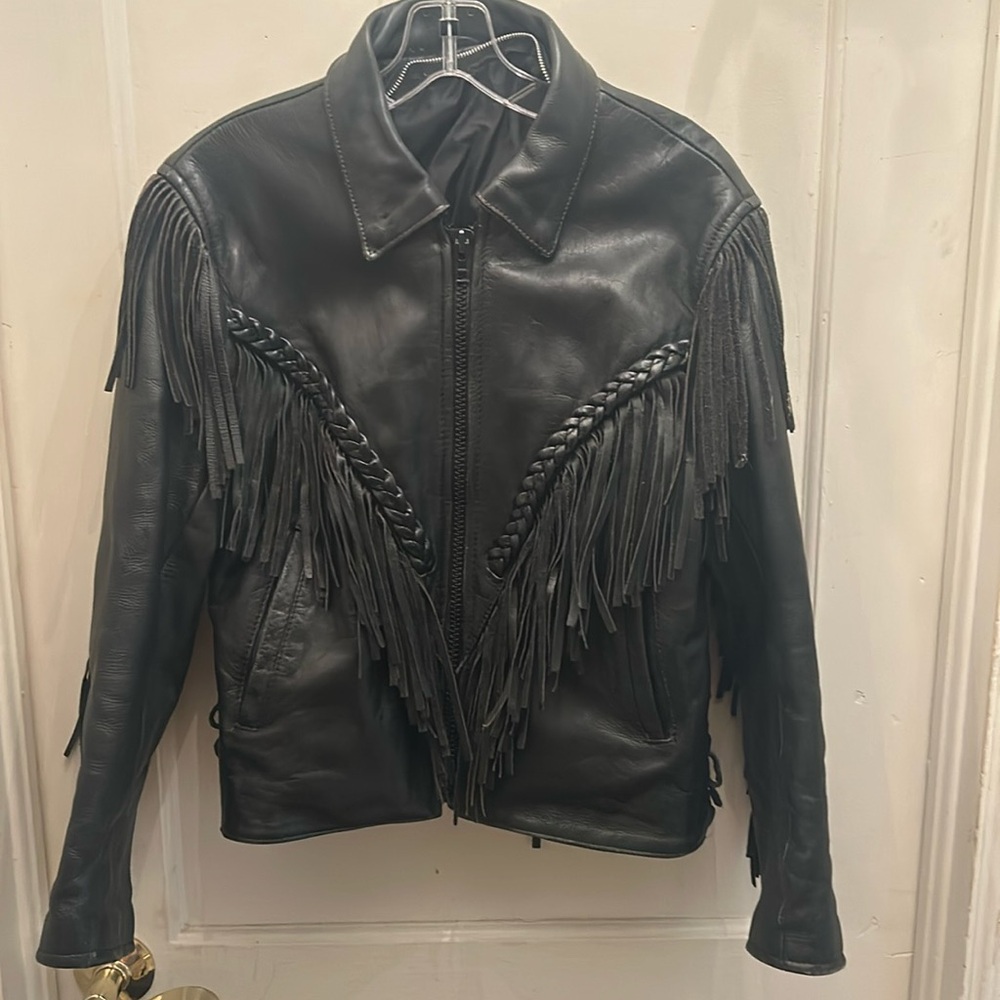 Heavy leather jacket, no lining ; fringe detail ; adjustable side laces